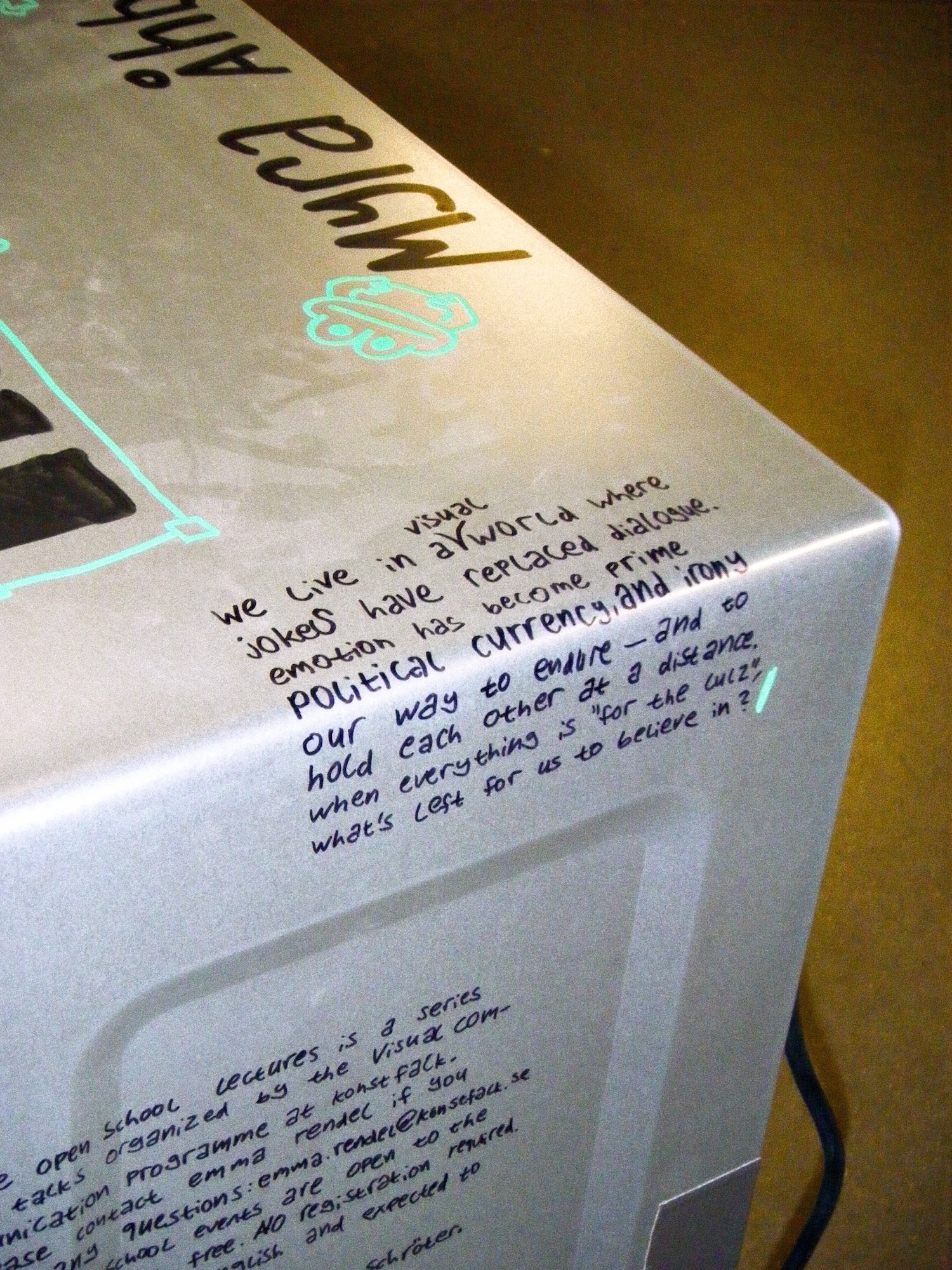 closeup of some descriptive text on the microwave. the text is handwritten and chaotic with some visible mistakes.